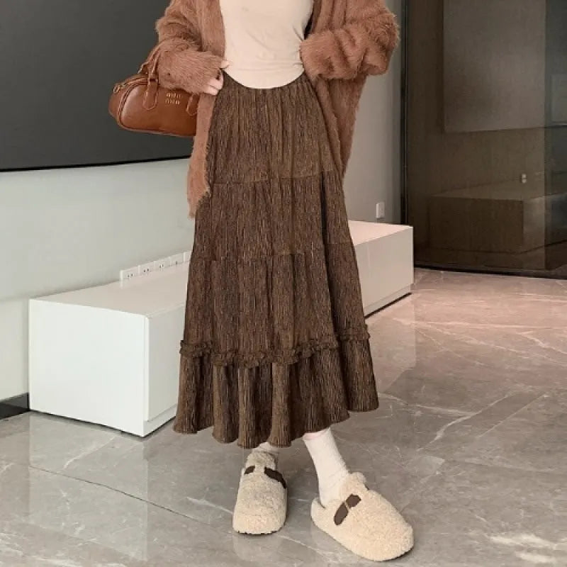 Women's beige corduroy A-line midi skirt with elastic waistband laid flat