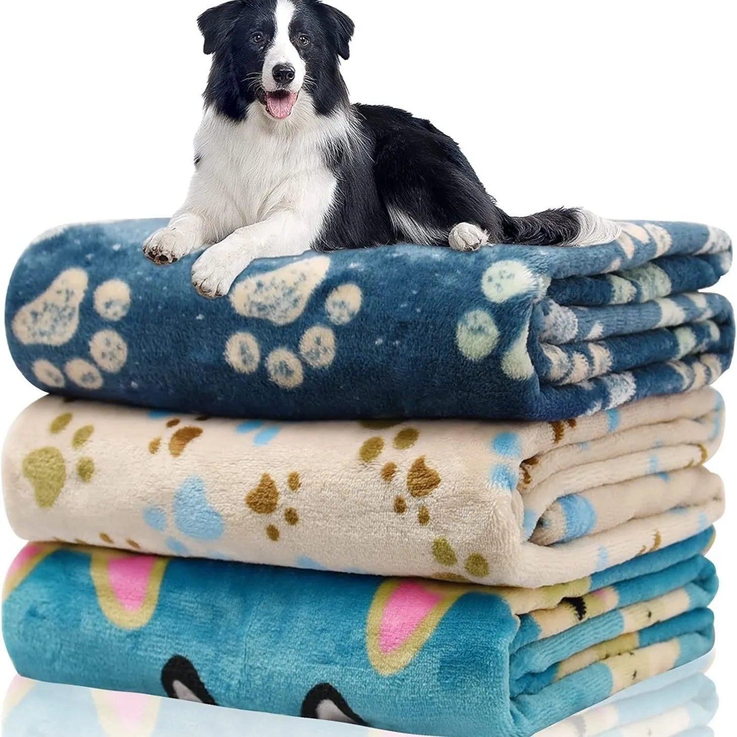 Blue cartoon dog paw patterned flannel pet blanket laid flat, showing its size.
