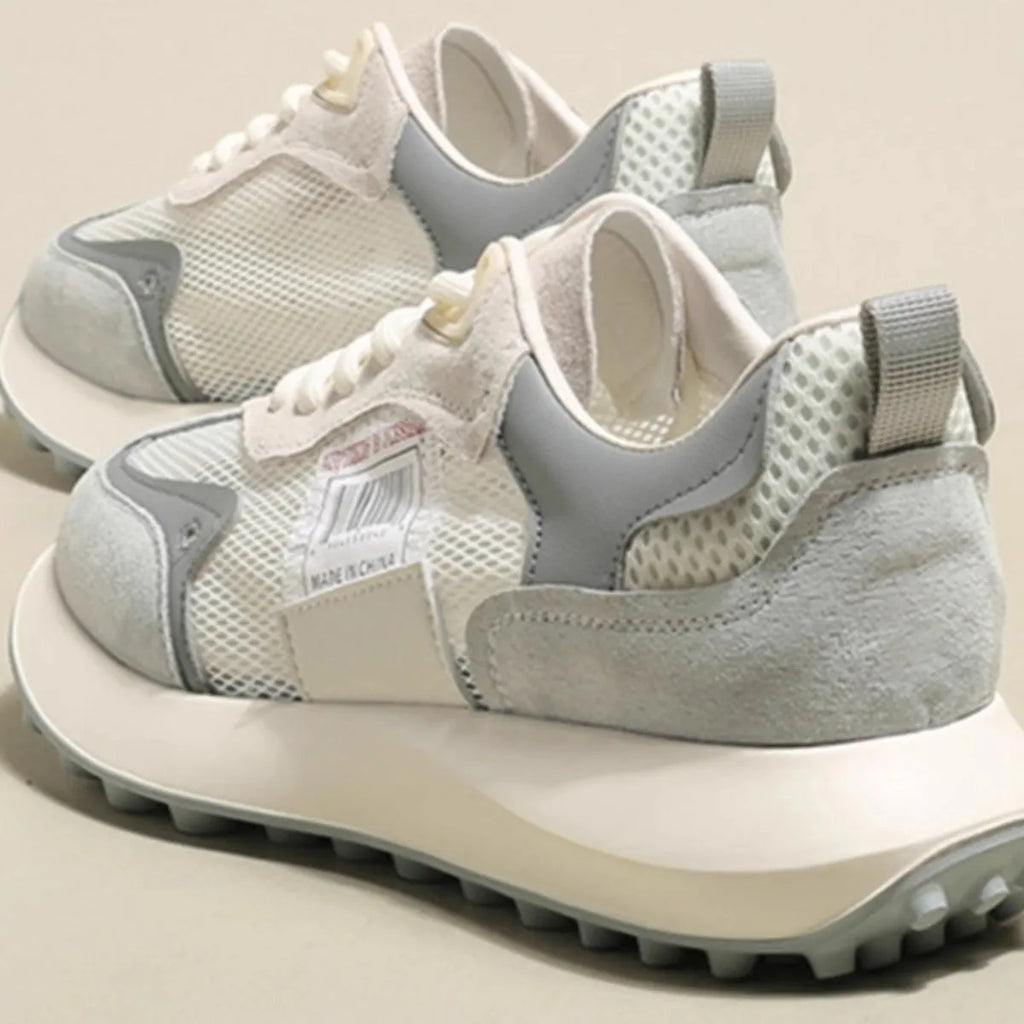 Women's low-top retro sneaker in grey with round toe, rubber sole, and mesh lining.