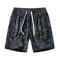 Men's camouflage pattern corduroy shorts with an elasticated high waistband on a plain background.