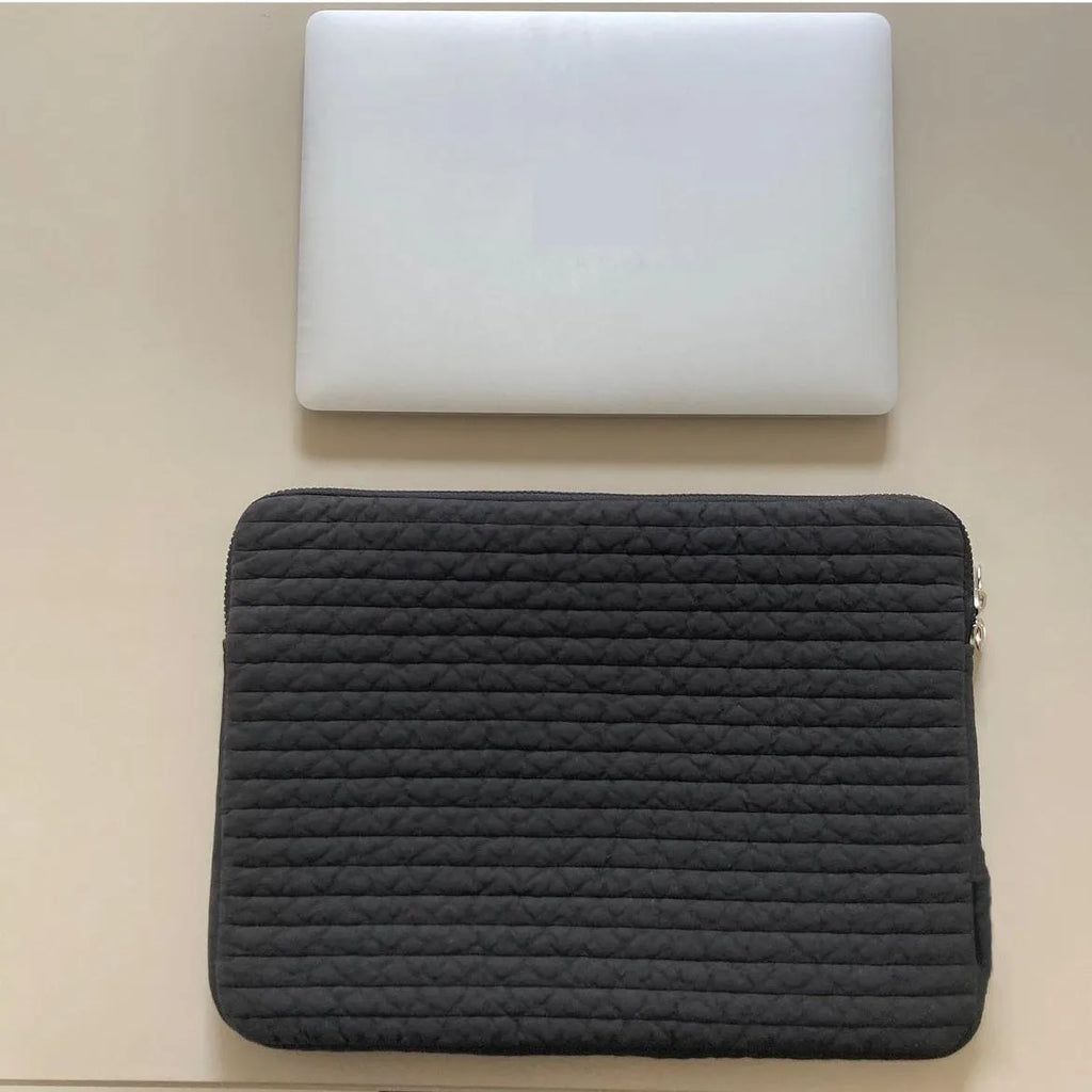 Black and white cotton cloth clutch-style laptop bag for tablets, showing internal coin pocket.