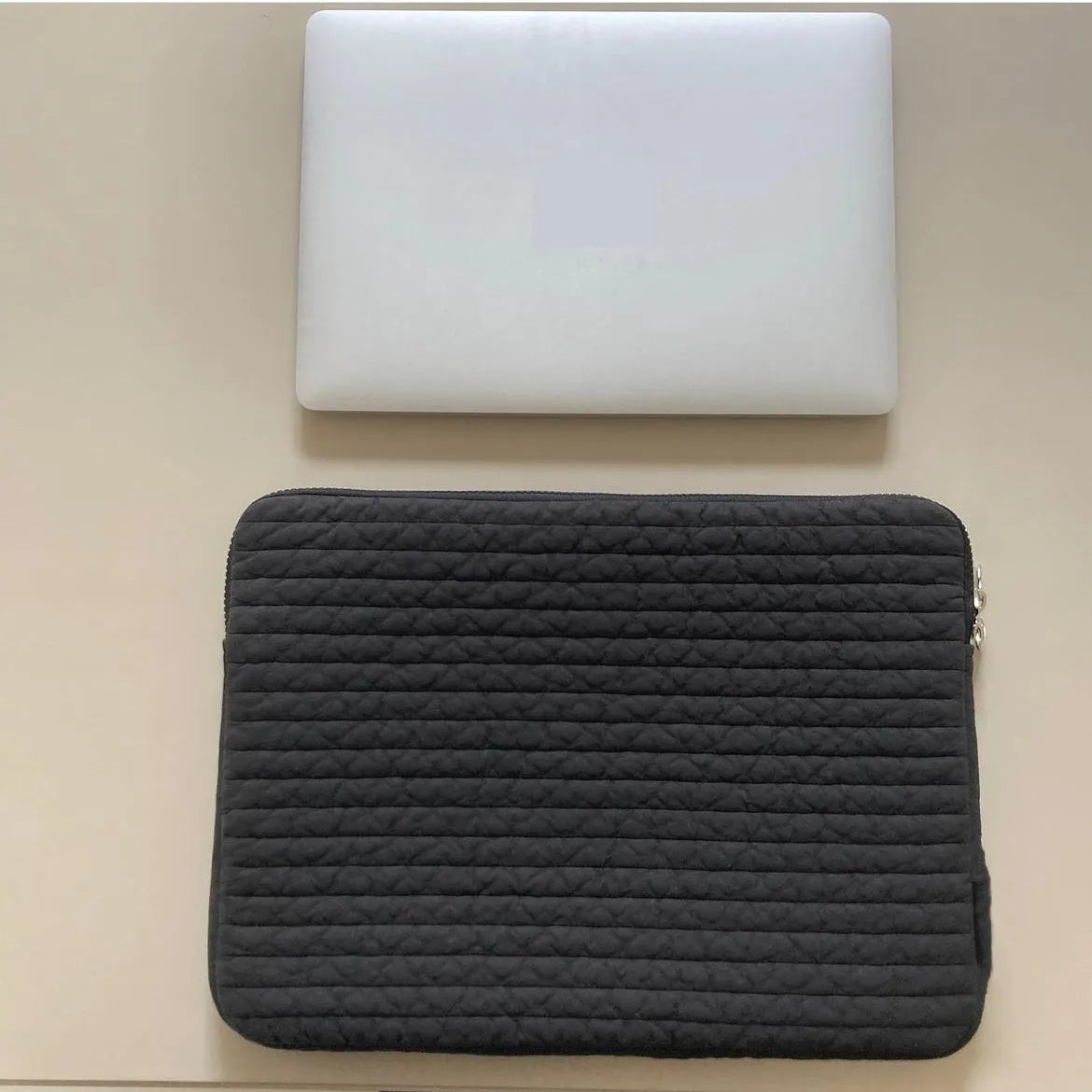 Black and white cotton cloth clutch-style laptop bag for tablets, showing internal coin pocket.