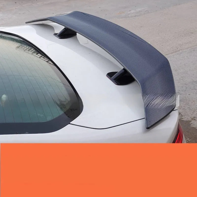 Punch-free adhesive mount car spoiler in ABS plastic, shown in carbon pattern finish.