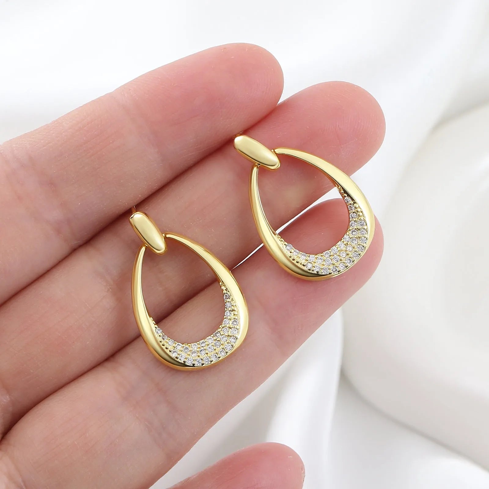 Yellow gold geometric drop earrings with round and oval elements measuring 2.6cm by 1.7cm