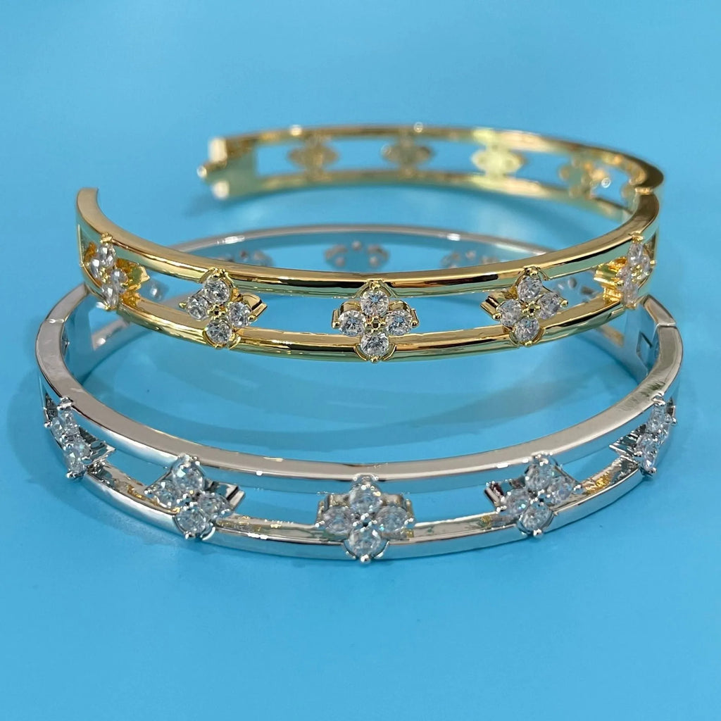 Women's hollow bracelet with four-leaf clover charm and zircon stones in gold or silver