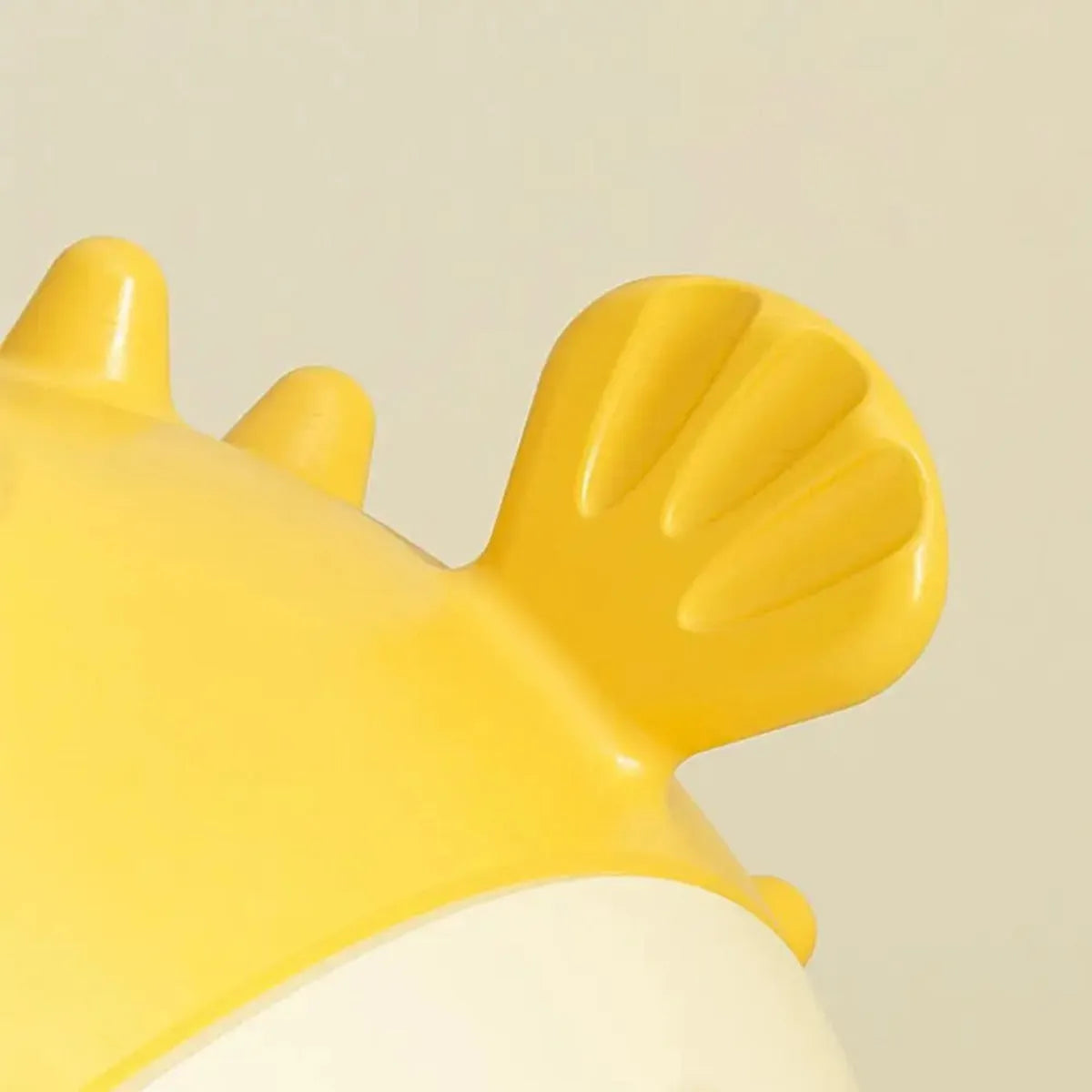 Yellow fish-shaped dog chew toy with convex texture and squeaker for aggressive chewers