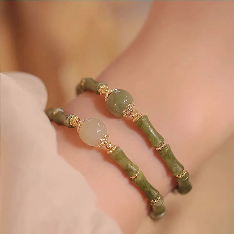 A geometric beaded bracelet made from dark green Hetian jade for women, showing a simple round style.
