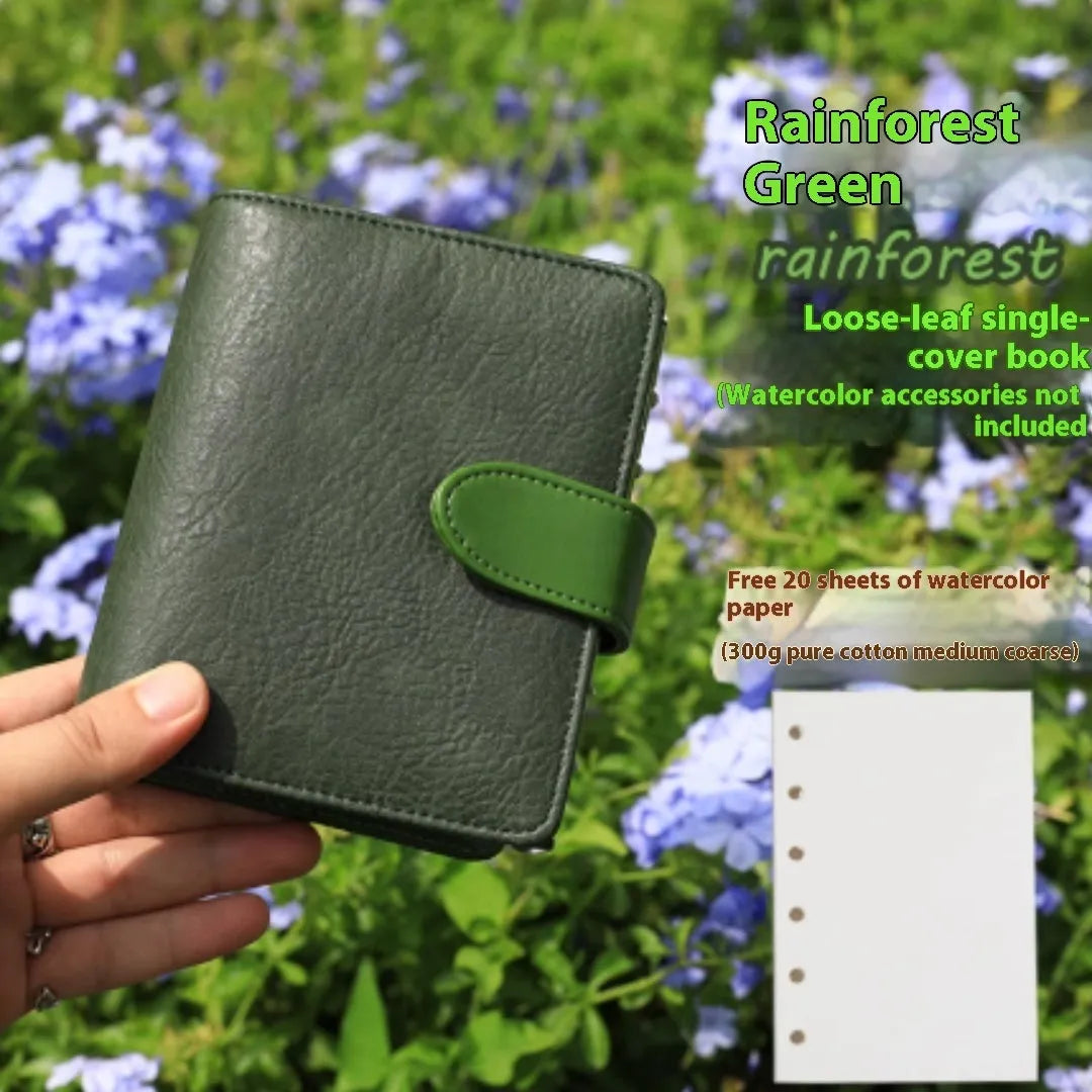 A7 format loose-leaf watercolour book in avocado green, open to show painting pages