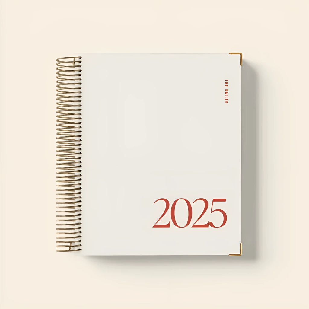 Cherry Red coil notebook open to show daily schedule pages and wire-bound spine