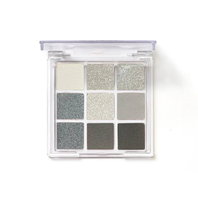 Nine-colour smoked eyeshadow palette showing white, silver, black, and iron grey shades in compact case