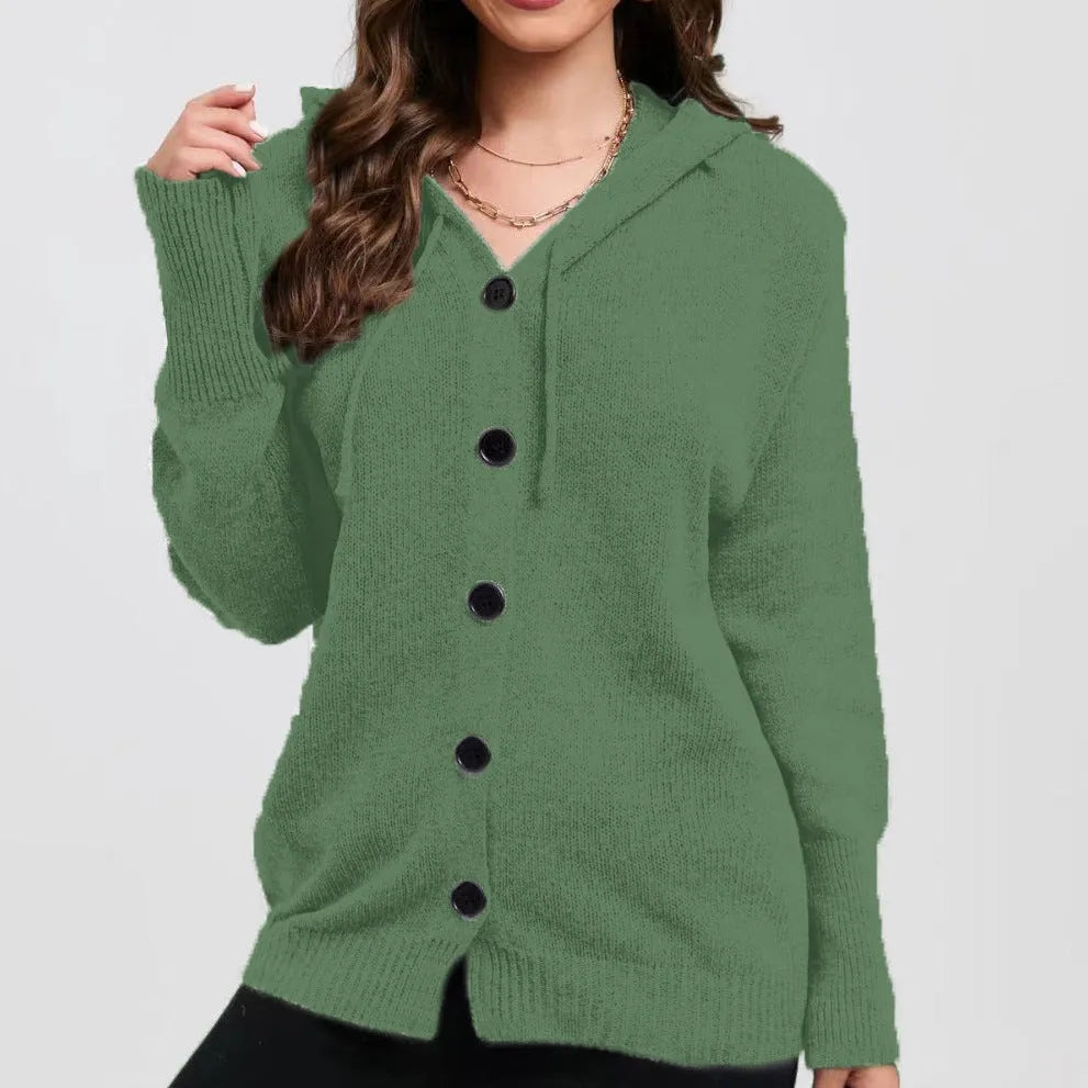 Woman wearing a thick, loose-fit grey hooded cardigan sweater with long sleeves.