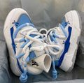 Women's thick bottom grey retro clunky sneakers with high heel on a white background.