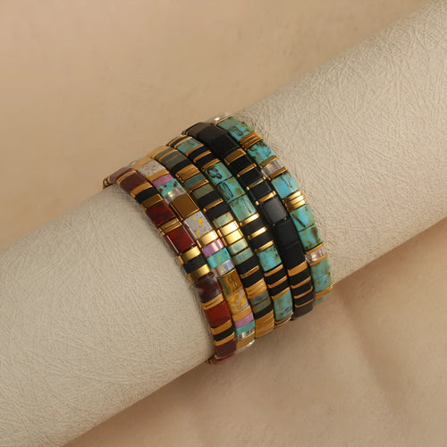 Geometric pull bead bracelet with round glass beads in multiple colour options.