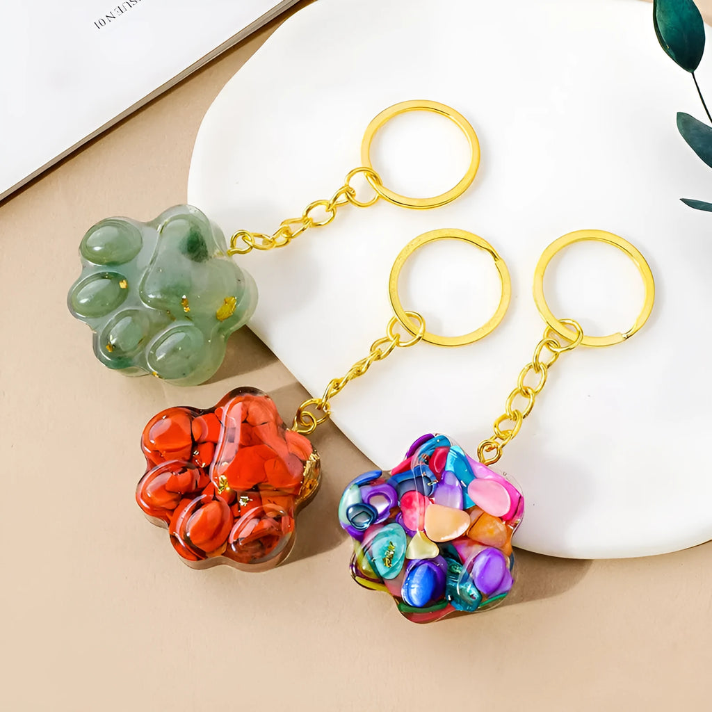 Natural crystal cat's paw shaped pendant on a silver keychain ring, shown in a random colour.