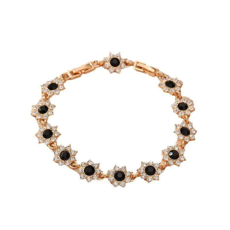 Electroplated zinc alloy flower bracelet in a choice of gold or silver finishes with coloured gemstone designs.