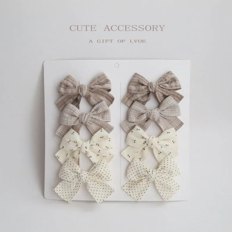 Children's fabric dovetail bow hair clips in eight pattern options