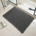 Modern checkered pattern absorbent non-slip bathroom floor mat in a neutral colour on tiled floor.