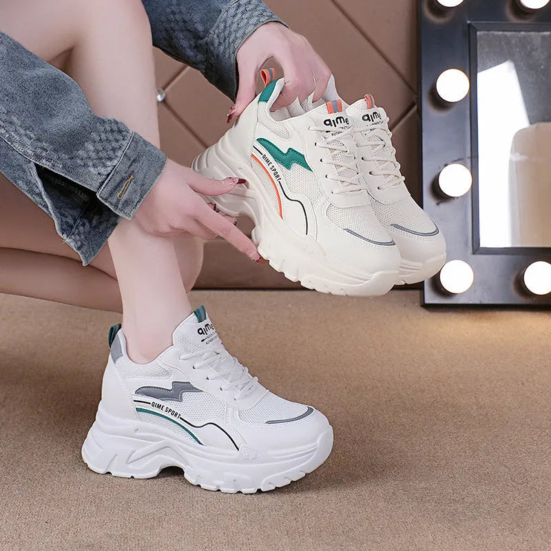 White women's dad shoes with cross shoulder straps, breathable mesh, and a rubber sole.