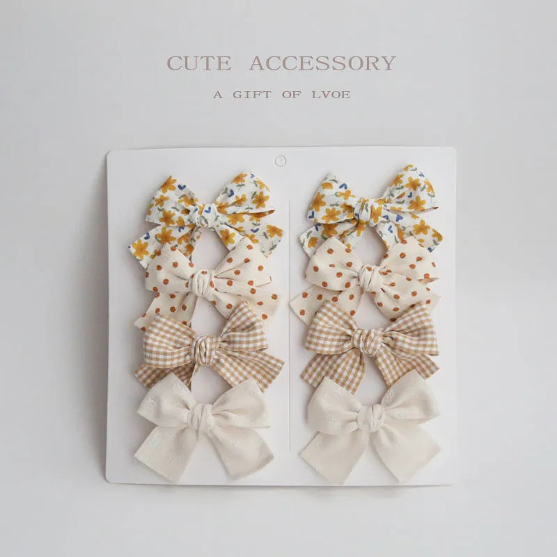 Children's fabric dovetail bow hair clips in eight pattern options