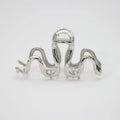 Silver metal Slytherin serpentine hair clip barrette measuring 10.5cm on a dark background