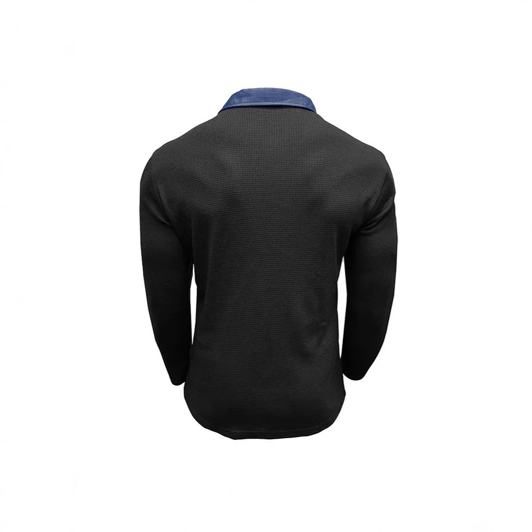 Man modelling a loose-fit long sleeve polo shirt with a waffle-texture fabric in a solid colour.