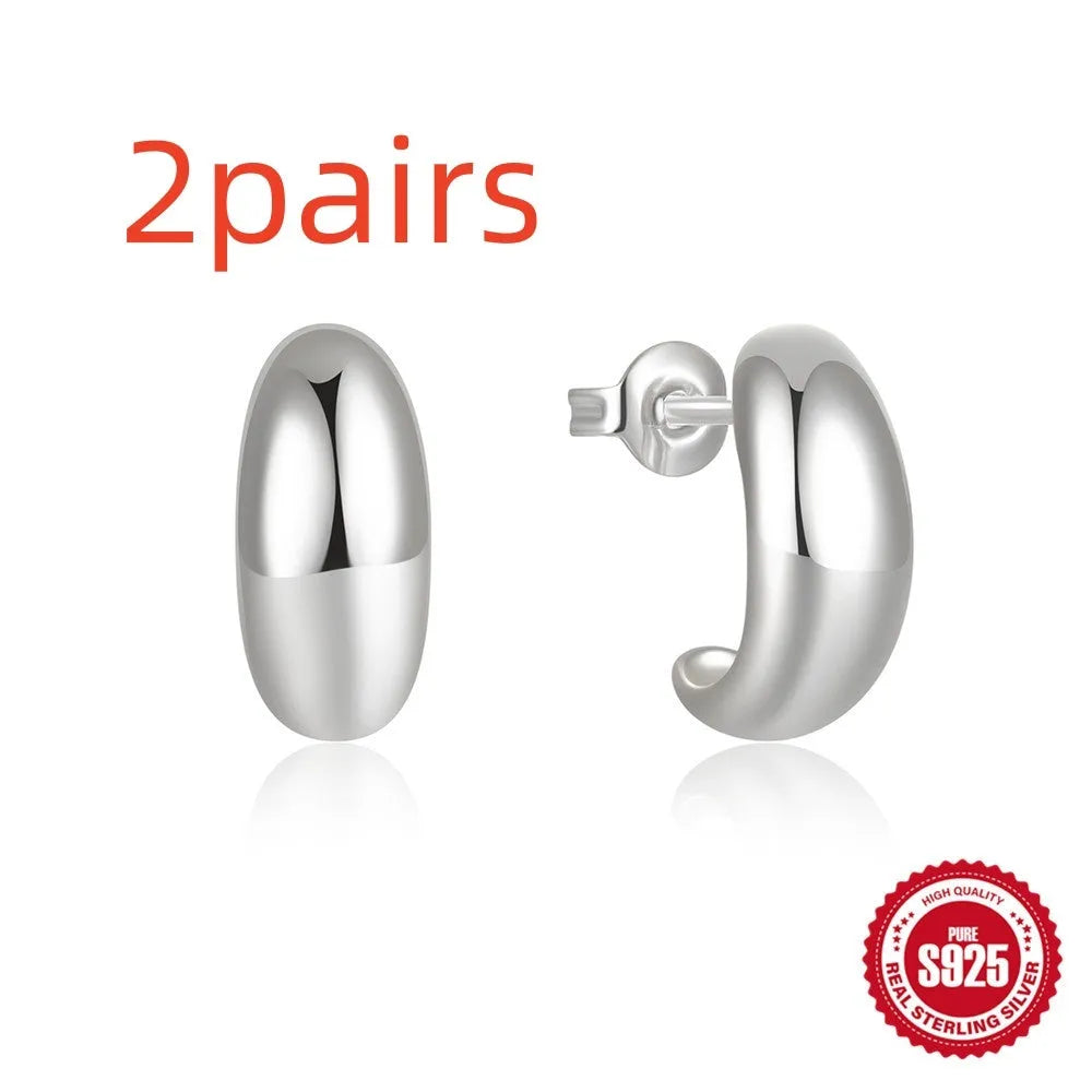 Sterling silver C-shaped stud earrings with electroplated gold finish