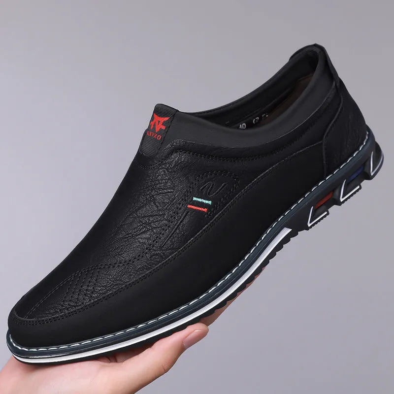 Men's black casual leather slip-on shoe with rubber sole and leather toe cap detail