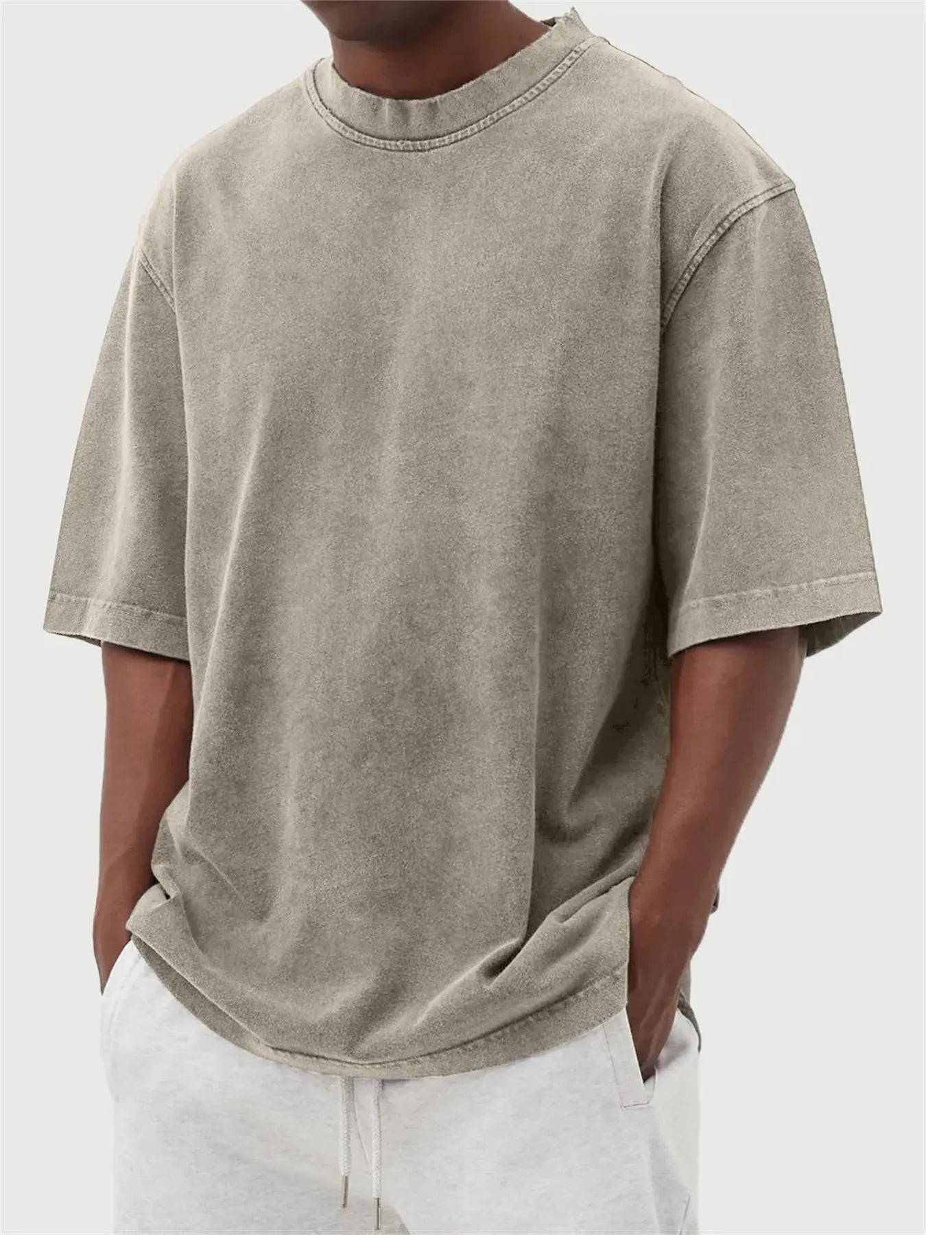 Men's loose fit pullover T-shirt in a stone-washed distressed solid colour, shown in army green.