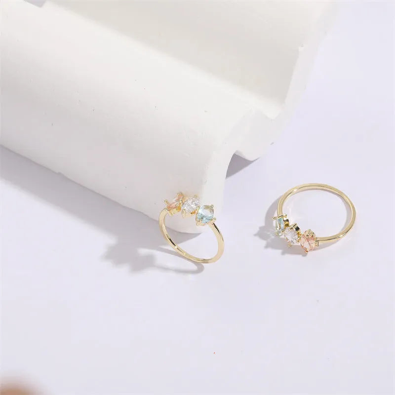 Gold electroplated geometric women's ring with triangular elements and horse eye tricolor zircon birthstone