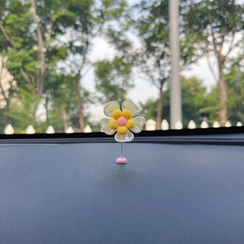 Small plastic swing decoration for car dashboard measuring 50mm by 35mm in multiple colours