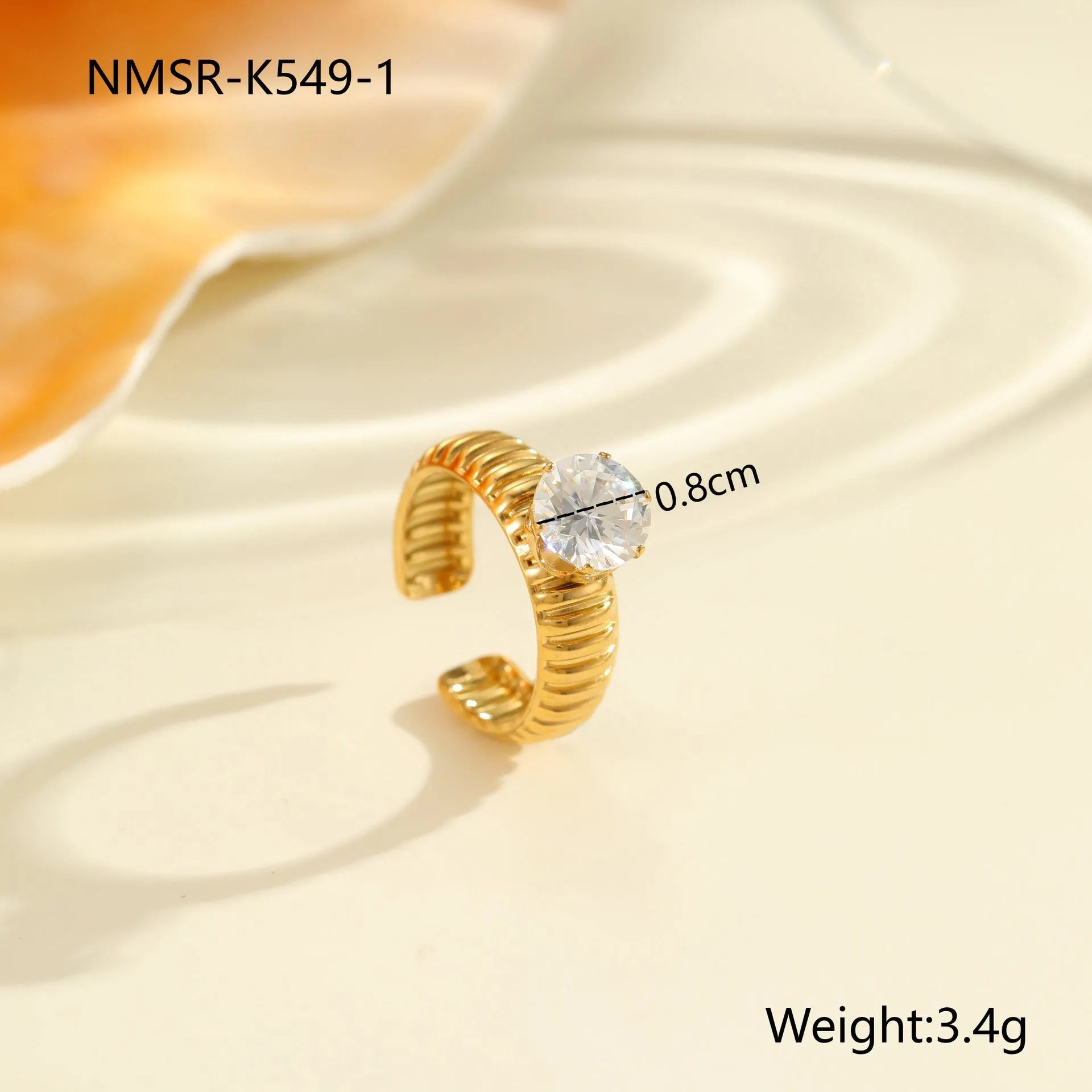 Gold-coloured stainless steel open ring with zircon stones in a geometric heart design.