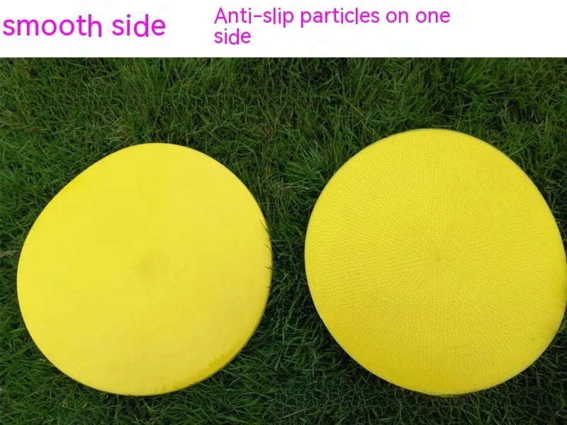 Flat, round yellow football training target disc with 23cm diameter on grass.