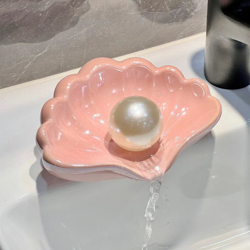 Shell-shaped plastic soap dish in white or pink for bathroom use
