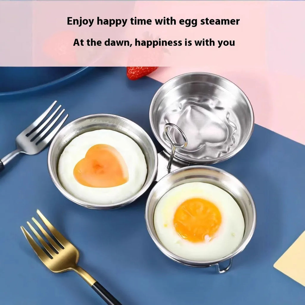 Compact stainless steel heart-shaped electric egg steamer on a kitchen counter.