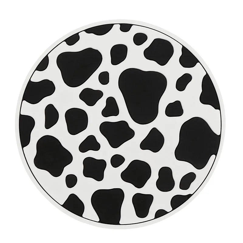 Black and white checkerboard pattern PVC car cup holder mat inserted in a vehicle centre console.
