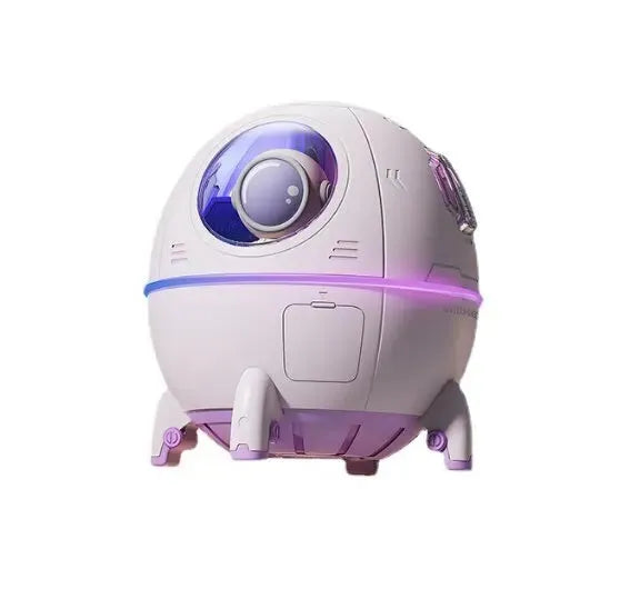 Light purple astronaut shaped USB humidifier with colourful LED light on a desk