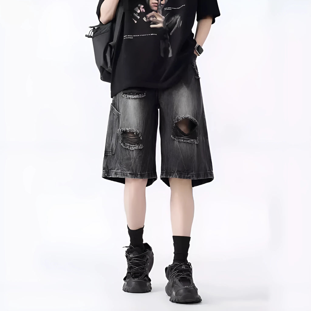 Loose washed blue denim shorts with a ripped knee detail on a mannequin, showing the retro fit.