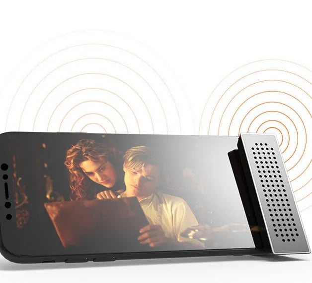 Mini mobile phone amplifier bracket on desktop enhancing smartphone sound in black, blue, pink or orange
