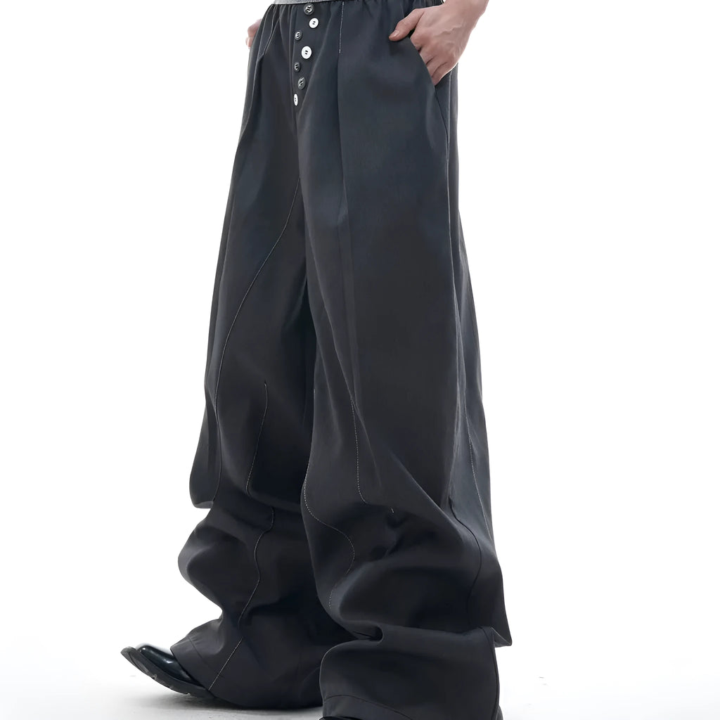 Men's grey straight-leg high-waisted trousers with a button-fly opening on a neutral background.