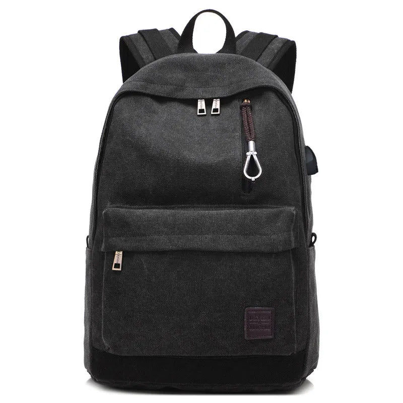 Canvas backpack with USB charging port showing computer compartment and zipper pocket