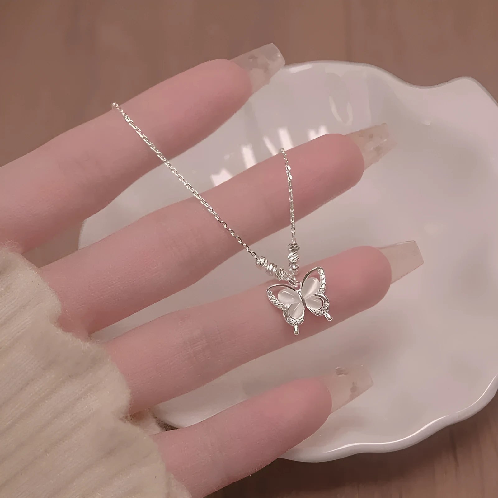 Silver butterfly pendant necklace on adjustable 41-50cm chain with cross link detail
