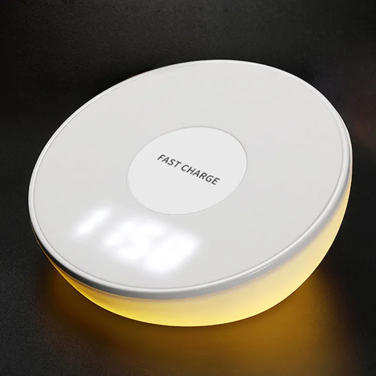 White wireless charger with digital clock display and night light feature on a bedside table