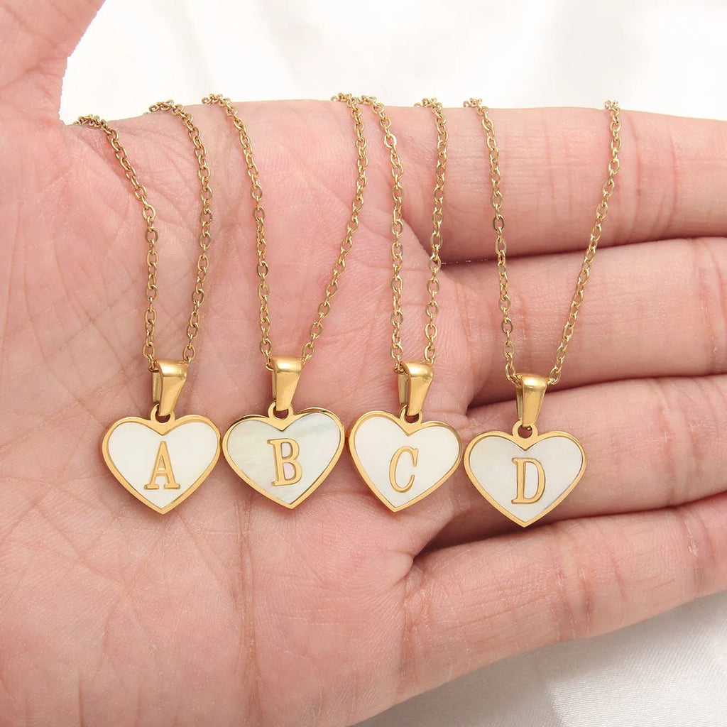 Gold plated heart-shaped necklace with white shell pendant on adjustable stainless steel chain
