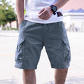 Man wearing loose-fit army green cotton blend workwear shorts with an elastic waist.