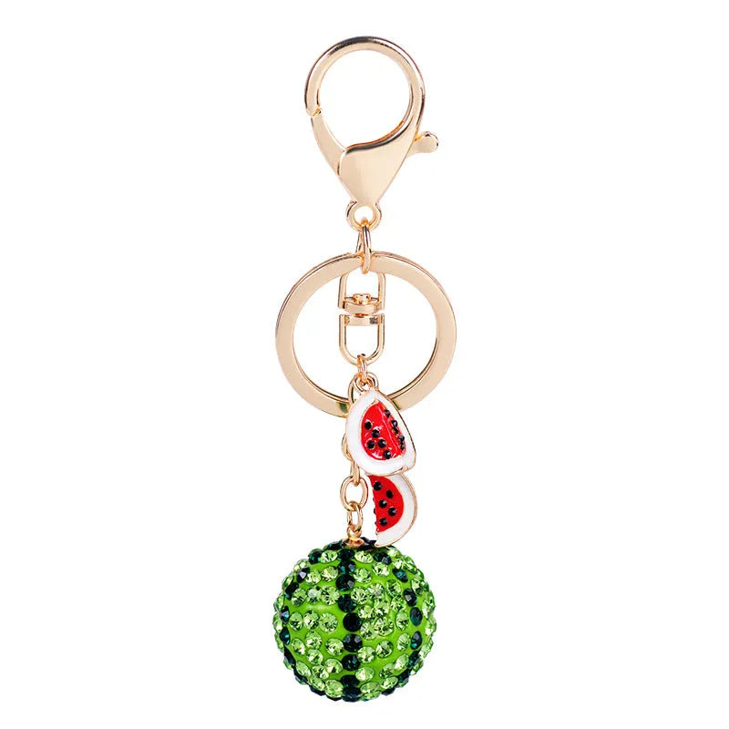 Green zinc alloy watermelon-shaped keychain on a keyring, showing detailed fruit slice design.