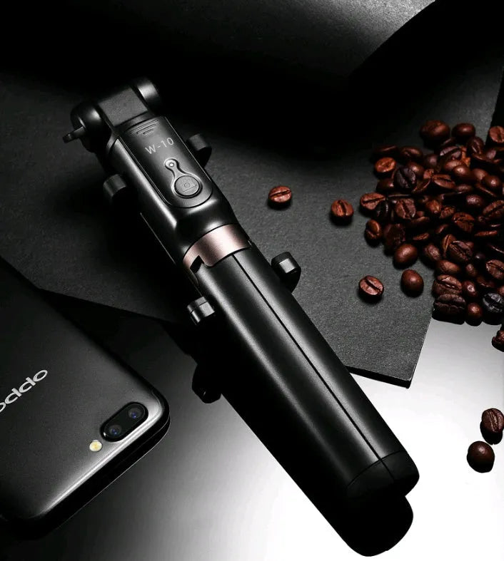 Aluminium alloy Bluetooth tripod selfie stick with remote control extended, holding a mobile phone.