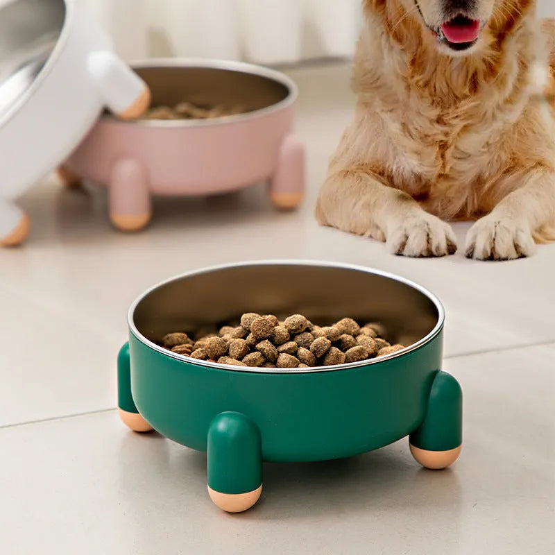 Green stainless steel pet bowl with non-slip base and high foot on a kitchen floor