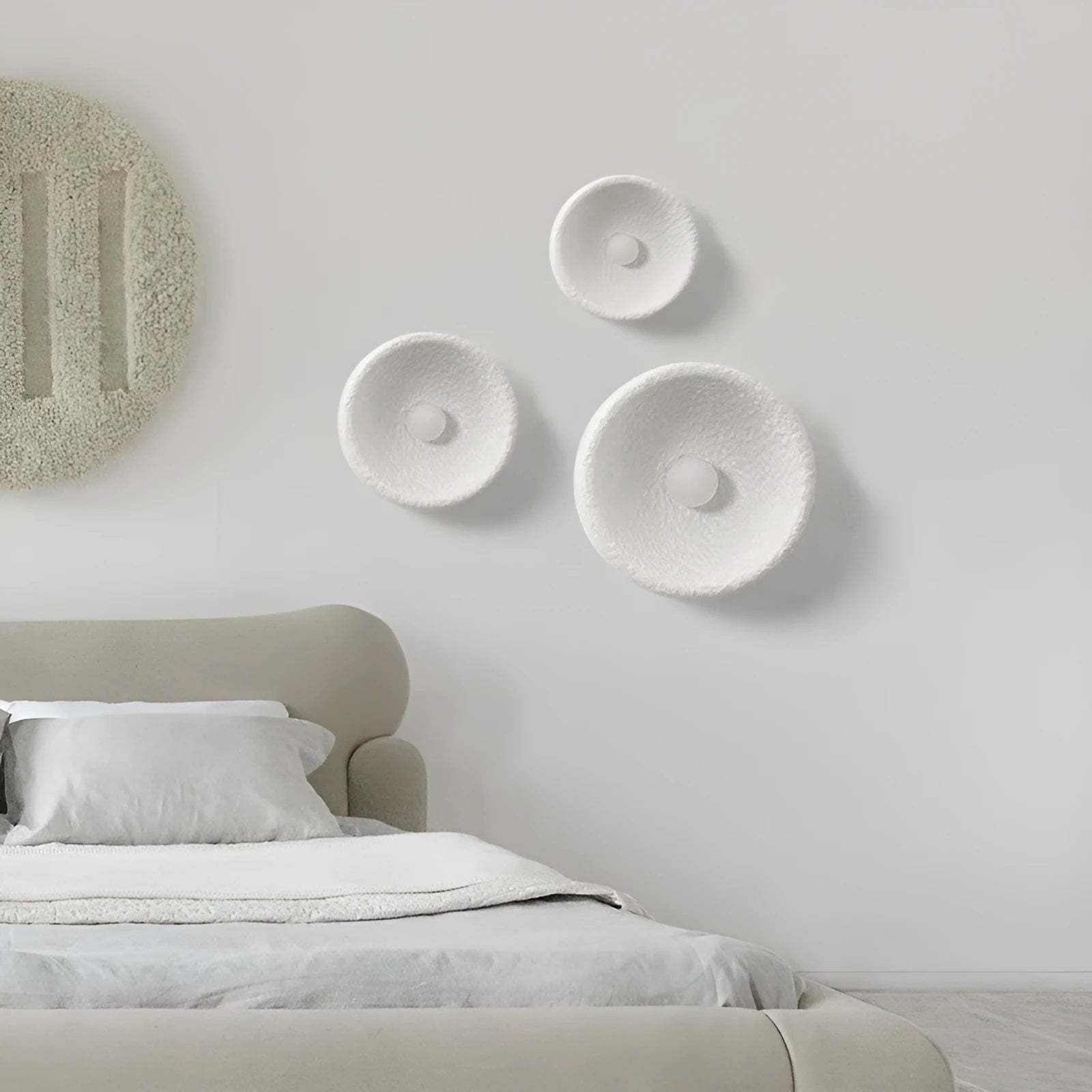 Japanese-style wall lamp with resin shade in three diameter sizes on white wall