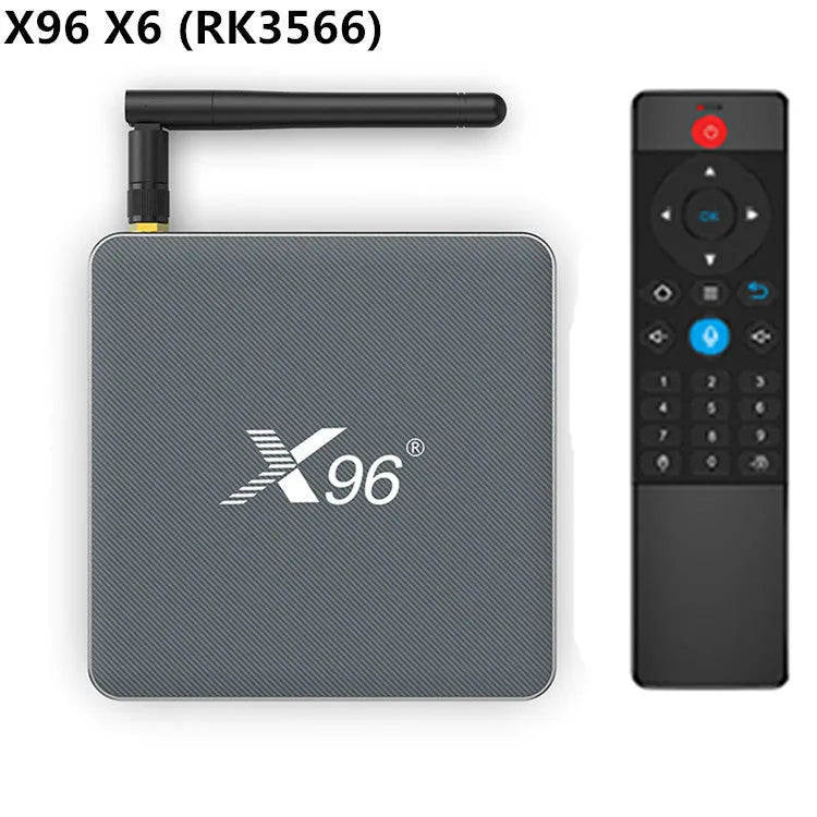 Android smart TV set-top box with voice remote control on a wooden table.