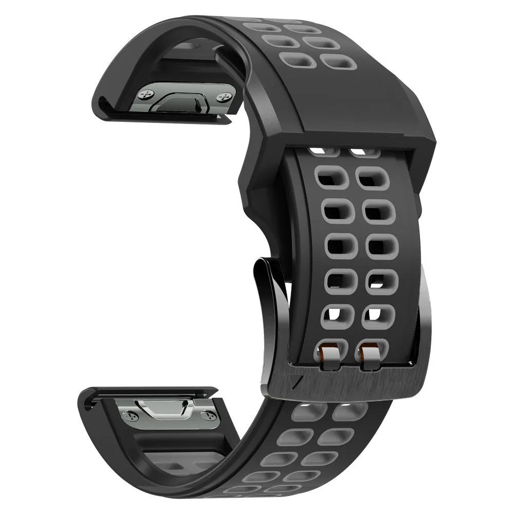 Close-up of a two-tone black and orange silicone watch strap with quick-release pins and a pin buckle.